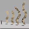 Spiral Wooden Art Installation Made Of Book Pages With Curved Upward Design And Person Nearby