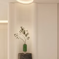 Modern Foyer Hallway Design With Light Colored Walls Stone Pillar Green Vase And Small Plant
