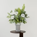 Decorative Ornament Set With White Vase White Flowers Green Leaves On Small Brown Round Table