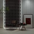 Modern Black Accent Chair With Metal Frame Side Table Green Plant And Grid Wall Artwork