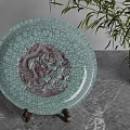 Celadon Plate With Dragon Relief Decorative Ornament Set On Wooden Stand And Bamboo Plant