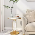 Elegant Round Side Table With Marble Top And Golden Frame By Beige Sofa With Pillow