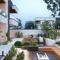 Modern Courtyard Garden With Lush Green Plants Wooden Seating And Stone Pathway