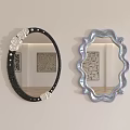 Oval Black Frame Mirror with White Rose Decor and Scalloped Pearlescent Mirror Reflecting Room Interior