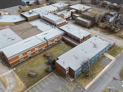 Aerial View Of Multiple Brick And Metal Buildings With Gray Roofs And Parking Lot 3d model