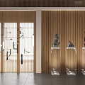 Black Carved Sculptures Display On Transparent Pedestals With Wooden Vertical Slat Wall