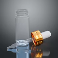 Clear Glass Empty Bottle With Gold Cap And Dropper Tool On Black Surface