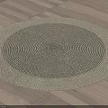 Round Woven Rug With Beige And Dark Gray Concentric Circles On Wooden Floor
