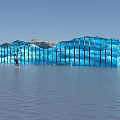 Blue Wave Shaped Glass Sculpture with Person Water Reflection and Mountain Sky