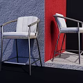 Modern Bar Stools With Metal Frame And White Seat Displayed Against Blue Red Walls