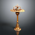 Elegant Golden Pedestal Table With Decorative Candles On Top And Intricate Carved Decorations