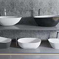 Different Colored Bathtubs On Multiple Shelves With Faucets Against Gray Wall Background