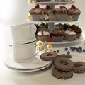 Colorful Cupcakes On Tiered Stand With Cookies Blueberries Chocolate Pieces And White Cup