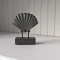 Black Scallop Shell Carving Sculpture On Gray Base White Tabletop Wooden Wall