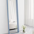 Stylish Blue Framed Mirror Reflecting White Curtains Sofa and Flowers
