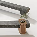 Modern Landscape Seats With Gray Stone Surface And Copper Bases Holding Small Potted Plants