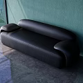 Black Leather Three Seater Sofa In Modern Minimalist Room With Green Wall And Concrete Floor