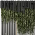 Green Plant Wall With Hanging Vines And Black Slatted Panels On Concrete Background