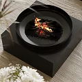 Modern Black Round Fireplace With Flames Wood Logs On Black Square Base Wooden Tabletop