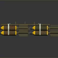 Two Yellow Brown Cylindrical Ordnance Devices With Metal Straps Fins And Dark Surface Reflection