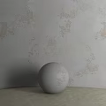 White Sphere Component Placed On Surface Against Textured Wall With Vintage Patterns