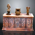 Antique Wooden Cabinet Featuring Carved Designs With Two Small Busts And Pottery Jar On Top