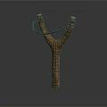 Wooden Y Shaped Slingshot With Black Rubber Band Isolated On Dark Background