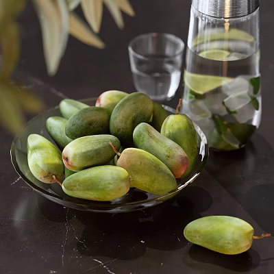 Green Mangoes on Glass Plate with Water Pitcher Lemon Slices and Ice Cubes on Table 3d model