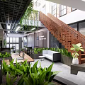 Public Office Space With Open Design Green Plants Staircase And Comfortable Seating