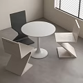 Modern White Round Table With Geometric Black And Beige Chairs In Minimalist Room