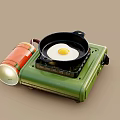 Portable Green Gas Stove with Frying Pan and Fried Egg for Home Kitchen Cooking