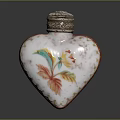 Elegant Heart Shaped Perfume Bottle With Colorful Floral Patterns And Metallic Cap