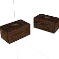 Two Carved Wooden Boxes With Golden Accents And Intricate Decorative Design
