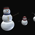 Three Snowmen Figurines With Different Sizes Black Red Hats And Blue Scarf On Black Background