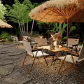 Outdoor Café With Straw Umbrellas Japanese Signage Green Plants And Stone Path