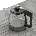 Stylish Transparent Glass Teapot Featuring Stainless Steel Lid And Black Handle On Marble Countertop
