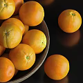 Fresh Oranges In A Bowl And Scattered On Black Background
