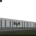 Modern Industrial Warehouse Exterior With Large Windows Trees Parking Lot And Grass Area