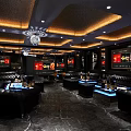 Luxurious KTV Interior Design With Black Leather Sofas Blue Lighting Chandeliers And Wall Screens