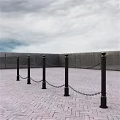 Public Facility With Black Posts Chain Links And Brick Paved Square Under Cloudy Sky 3d model