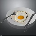 White Plate With Fresh Fried Egg Silver Fork And Knife On Black Surface