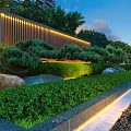 Residential Landscape With Illuminated Wooden Screen Lush Greenery Pine Trees Stones Against High-Rise Buildings