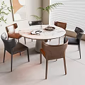 Modern Round Dining Table with Leather Chairs in Bright Interior with Plants and Artwork
