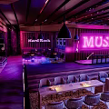 Hard Rock Bar Interior With Purple Lighting Music Neon Sign And Stage Seating Area