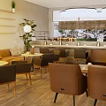 Warm Cozy Café Interior With Hanging Lamps Sofa Seats And Green Plants