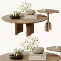 Round Wooden Coffee Table With Unique Leg Design Books Woven Vase And Green Plant