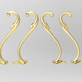 Golden Carved Decorative Pieces With Intricate Curved Designs And Ornate Patterns