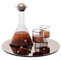 Conical Glass Container With Brown Liquid And Two Glass Cups On Round Tray Metal Decorations