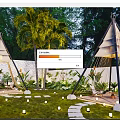 Evening Courtyard Garden With Teepee Structures Palm Trees Stepping Stone Path White Lights And Lush Greenery