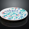 Decorative White Plate With Green Red Blue Floral Patterns And Reflection On Black Background